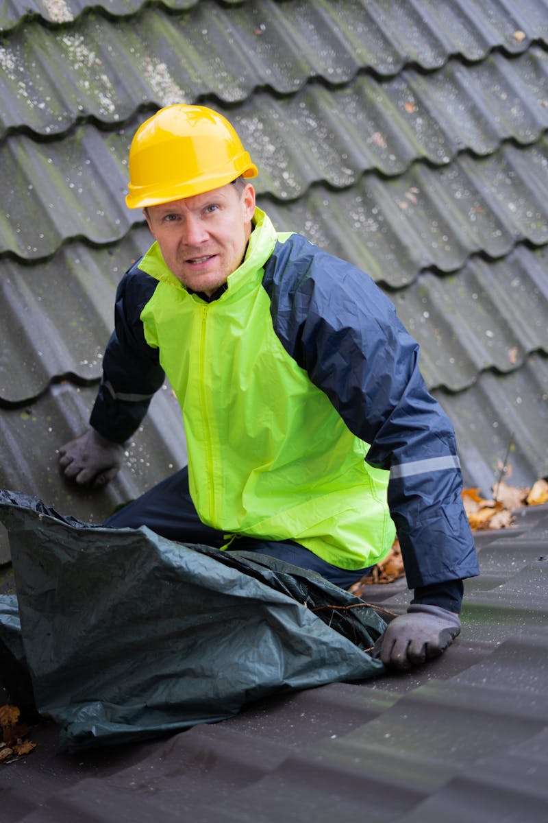 Professional roofer repairing shingles on Louisiana home